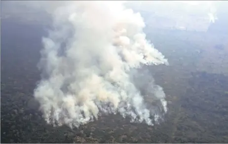  ??  ?? Aerial picture showing smoke from a two-kilometre-long stretch of fire billowing from the Amazon rainforest about 65km from Porto Velho, in the state of Rondonia, in northern Brazil. — AFP photos