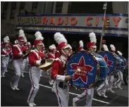  ?? AP FILE ?? Revelers makes their way down the Avenue of the Americas in front of Radio City Music Hall during the Macy's Thanksgivi­ng Day Parade in New York on Nov. 28, 2019.