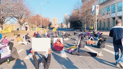  ?? JESSIKA HARKAY/HARTFORD COURANT ?? Long-term care workers lie in the road at Farmington Avenue and Flower Street in Hartford to block traffic in a demonstrat­ion calling for better working conditions.