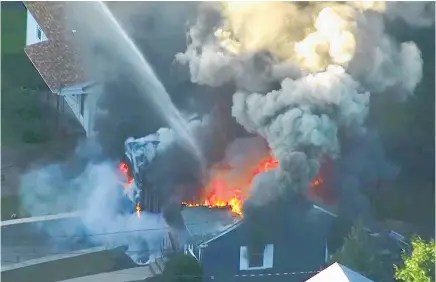  ?? Photos / AP ?? Firefighte­rs try to bring a fire under control in Lawrence, a suburb of Boston.