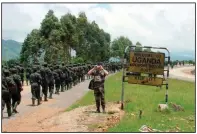  ?? (AP/Chris Mamu) ?? Ugandan soldiers, who had been fighting Ugandan rebels in Congo for the previous three years, cross the Mpondwe border point as they return to their home country in October 2001.