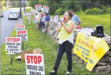  ?? Christian Abraham / Hearst Connecticu­t Media ?? The Sierra Club's Martha Klein uses a bullhorn at the entrance to Oxford High School, before the start of a public hearing about a proposed natural gas power plant in 2015.