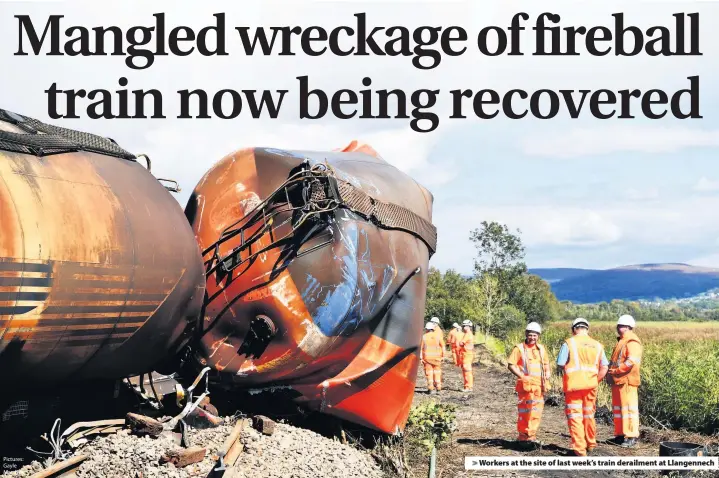  ?? Pictures: Gayle Marsh ?? Workers at the site of last week’s train derailment at Llangennec­h