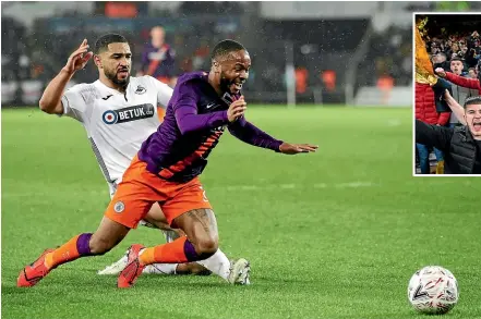  ?? GETTY IMAGES ?? Manchester City winger Raheem Sterling is brought down, resulting in a penalty for his team in their comeback 3-2 win over Swansea City. Replays showed the penalty was incorrectl­y awarded.