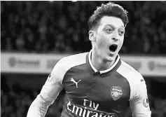  ?? — AFP photo ?? Mesut Ozil celebrates scoring the team’s second goal during the English Premier League match between Arsenal and Liverpool at the Emirates Stadium in London in this December 22, 2017 file photo.