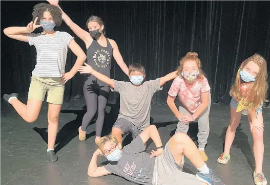  ?? BEVERLY THEATRE GUILD CHICAGO ?? Sophia Smith, back row, from left, Olivia See, Lucas Mora, Grace Regalado, Layla LaFlame and Ryan Valecek, lying on floor, are among the cast for the Beverly Theatre Guild Chicago’s “Matilda the Musical” from Oct. 8-10 at Morgan Park Academy Arts Center in Chicago.