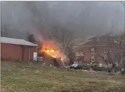  ?? COURTESY OF EXETER TOWNSHIP FIRE DEPARTMENT ?? A garage is was ablaze within feet of a home Wednesday morning at Limekiln and Wegman roads in Exeter Township.