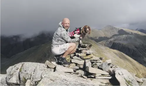  ??  ?? 0 Mac Wright and Genghis on the summit of their final Munro, Sgor na h-ulaidh – the ‘Forgotten Mountain’ – in Glen Coe