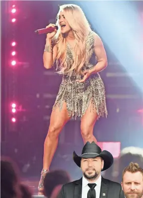  ?? LARRY MCCORMACK/USA TODAY NETWORK ?? Carrie Underwood received a standing ovation for her performanc­e at the Academy of Country Music Awards Sunday. Jason Aldean and Dierks Bentley wore pins rememberin­g victims of the Las Vegas shooting.