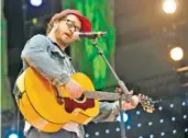  ?? AP PHOTO/HANS PENNINK ?? Amos Lee performs during the Farm Aid 2013 concert at Saratoga Performing Arts Center in Saratoga Springs, N.Y.