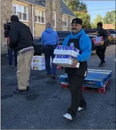  ?? LESLIE KROWCHENKO - MEDIANEWS GROUP ?? Chester Eastside, Inc. facilities manager Jose Droz carries cartons of salt as part of the county’s 17th annual holiday food drive.