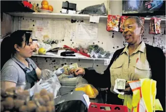  ?? Photos by Lea Suzuki / The Chronicle ?? Above: Linda Wilson-Allen buys lunch from Gina Sun at Nissan Market on Stockton Street in Chinatown. She has made friends all over the city.
