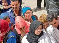  ?? AFP ?? People wait to receive the bodies of loved ones in the tunisian town of Sfax on Monday after more than 50 migrants drowned in the Mediterran­ean the previous day, the majority off the coasts of tunisia and turkey. —