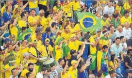  ?? AFP ?? Brazilian fans were in a buoyant mood after Philippe Coutinho gave the side the lead but the equaliser by Switzerlan­d in the second half stunned them into silence on Sunday.