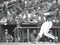  ?? Alex Brandon/Associated Press file photo ?? ■ Washington Nationals’ Bryce Harper hits a two-RBI double during the fifth inning of a baseball game on June 8, 2018, against the San Francisco Giants at Nationals Park in Washington. Harper, Manny Machado, Craig Kimbrel and Dallas Keuchel will not be around when the bat and ball bags are opened at spring training throughout Florida and Arizona this week. They are among the dozens of free agents still looking for jobs.