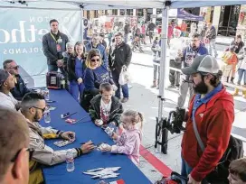 ?? Michael Minasi / Houston Chronicle ?? Hundreds line up for autographs from Houston Astros shortstop Carlos Correa and pitcher Michael Feliz during a toy drive on Saturday, Dec. 9, 2017, at Houston Methodist Emergency Care Center in The Woodlands.
