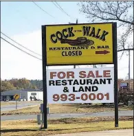  ?? Arkansas Democrat-Gazette/ERIC E. HARRISON ?? The sign on Maumelle Boulevard pointing the direction toward Cock of the Walk says “closed,” and a large banner proclaims the restaurant and the land is now for sale.