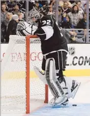  ?? Victor Decolongon Getty Images ?? JONATHAN QUICK kicks the puck out of the net after giving up an own-goal in the Kings’ 3-1 loss to the New York Rangers on Monday.