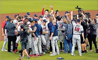  ?? Thomas Shea-USA TODAY Sports ?? Atlanta Braves players celebrate on the field after defeating the Houston Astros in Game 6 of the 2021 World Series on Nov. 2.