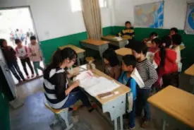  ??  ?? A First Grade Chinese class. The majority of students’ parents work outside the village, leaving their children behind to be cared for by relatives.