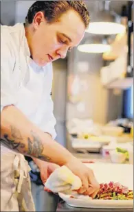  ?? Daley’s on Yates photo ?? Head chef Elliott Vogel prepares a dish at Daley’s on Yates.