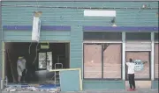  ?? (Arkansas Democrat-Gazette/Stephen Swofford) ?? A crew repairs the Oyster Bar on Markham Street last week. A car drove through the front of the Little Rock shop.