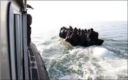  ?? THE ASSOCIATED PRESS ?? Migrants, mainly from sub-Saharan Africa, are stopped by Tunisian Maritime National Guard at sea during an attempt to get to Italy, near the coast of Sfax, Tunisia, on April 18.