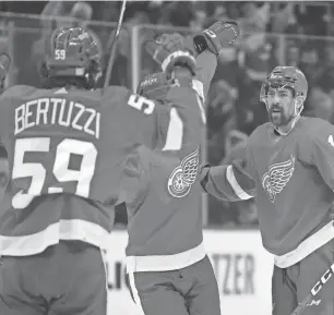  ?? PAUL SANCYA/AP ?? Red Wings defenseman Filip Hronek, right, celebrates his goal against the Predators in the Wings' 3-0 win over the Predators on Wednesday at Little Caesars Arena.