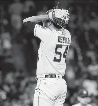  ?? Karen Warren / Staff photograph­er ?? Astros relief pitcher Roberto Osuna (54) gave up Nick Martini’s RBI double, which was the go-ahead run during the ninth inning Tuesday night at Minute Maid Park.