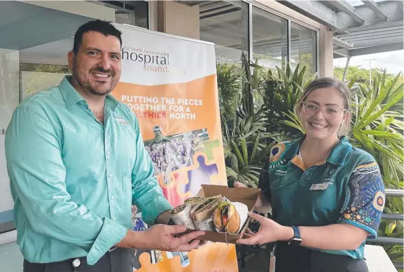  ?? ?? Hospital Foundation CEO Joe Cristaldi and Cairns nurse manager Alex Rodgers with donated meals. Picture: Sarah Carroll