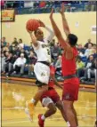  ?? PAUL DICICCO — THE NEWS-HERALD ?? Brush’s DJ Dial prepares to pass to a teammate against a Cornerston­e Christian defender on Jan. 28 at John Carroll University.