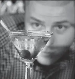  ?? LES BAZSO/ POSTMEDIA NEWS FILES ?? Clough Club head bartender Samuel Lacroix prepares a QCBC cocktail at the bar in Vancouver’s Gastown.