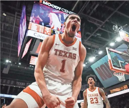  ?? SARA DIGGINS/AMERICAN-STATESMAN ?? Texas forward Dylan Disu celebrates a foul call during the second half of the Longhorns' 75-73 win over No. 9 Baylor on Saturday. It was Texas' first win over a ranked team this season.