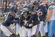  ?? [NAM Y. HUH/THE ASSOCIATED PRESS] ?? Bears cornerback Bryce Callahan (37) celebrates with teammates after intercepti­ng a pass against the Lions on Sunday in Chicago. The Bears won 34-22.