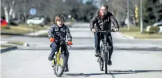  ?? THE CANADIAN PRESS FILES ?? Nico Montoya rides his bicycle with his father Felipe in front of his home in 2016. Felipe Montoya, a York University professor originally from Costa Rica, had to temporaril­y leave Canada when the government found that his 14- year- old son was not eligible for permanent residency because he has Down syndrome and might place an extra burden on the health system.