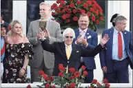  ?? Andy Lyons / TNS ?? Trainer Bob Baffert raises the trophy after winning the Kentucky Derby with Medina Spirit on May 1 at Churchill Downs in Louisville, Ky.