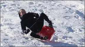  ??  ?? Spring wonderland: A sledger having fun at Aviemore in the Highlands