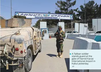  ?? AP ?? ■ A Taliban soldier stands guard at the gate of Hamid Karzai Internatio­nal Airport in Kabul yesterday.