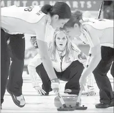  ?? THE ASSOCIATED PRESS ?? Manitoba skip Jennifer Jones watches her shot as second Jill Officer, left, and lead Dawn McEwen sweep during the Page playoff game against Alberta at the Scotties Tournament of Hearts in Moose Jaw, Sask. Friday.