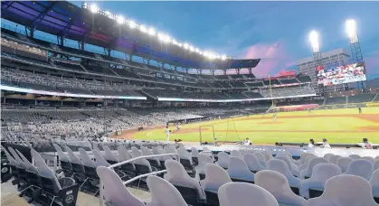  ?? JOHN AMIS/AP ?? During the shortened 2020 season, cardboard cutouts of fans occupied seats at a baseball game in Atlanta.