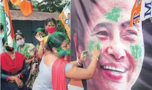  ?? PHOTO: PTI ?? Trinamool Congress activists celebrate their party's winning trend, in South Dinajpur