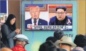  ?? AP ?? A TV screen showing images of US President Donald Trump and North Korean leader Kim Jong Un.