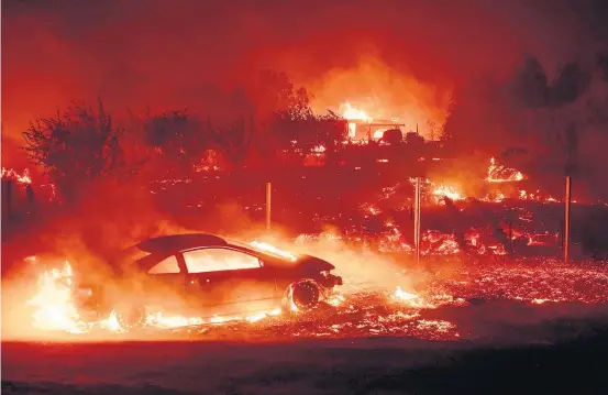  ?? JOSH EDELSON/AFP ?? Inferno. Carros e casas consumidos pelo fogo na cidade de Paradise, na Califórnia; 15 mil prédios estão ameaçados e milhares de pessoas fugiram de casa