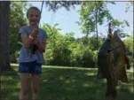  ?? RICHARD PAYERCHIN — THE MORNING JOURNAL ?? Emily Hanson, 9, of Wadsworth, shows off one of the sunfish she caught in the Black River Game Club Youth Fishing Derby held June 3.