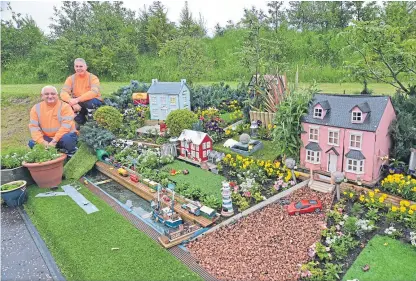  ??  ?? Rab Elder, left, and Alan Ratcliffe built the model village using odds and ends people threw away.