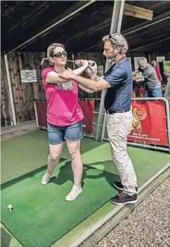  ?? RP-FOTO: ANDREAS ENDERMANN ?? Golf-Profession­al Joachim Wittmann zeigt einer blinden Spielerin im Golfclub Grafenberg, wie sie am besten Schwung beim Abschlag holt.