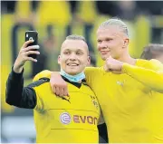  ?? REUTERS ?? Dortmund’s Erling Braut Haaland, right, takes a selfie with a fan after the match.