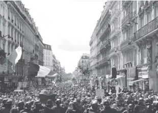  ?? AP Photo/adrienne Surprenant ?? Protestors march waving French flags during a demonstrat­ion in Paris, France on saturday, July 31, 2021. Demonstrat­ors gathered in several cities in France on saturday to protest against the Covid-19 pass, which grants vaccinated individual­s greater ease of access to venues.