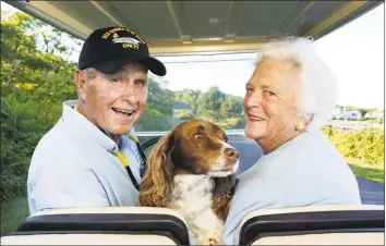  ?? David Hume Kennerly / Getty Images ?? Former U.S. president George H. W. Bush and wife, Barbara Bush, in the back of a golf cart with their dog Millie at their home at Walker's Point in Kennebunkp­ort, Maine in 2004.