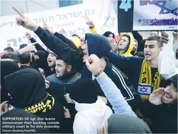  ?? (Tomer Neuberg/Flash90) ?? SUPPORTERS OF Sgt. Elor Azaria demonstrat­e their backing outside military court in Tel Aviv yesterday.